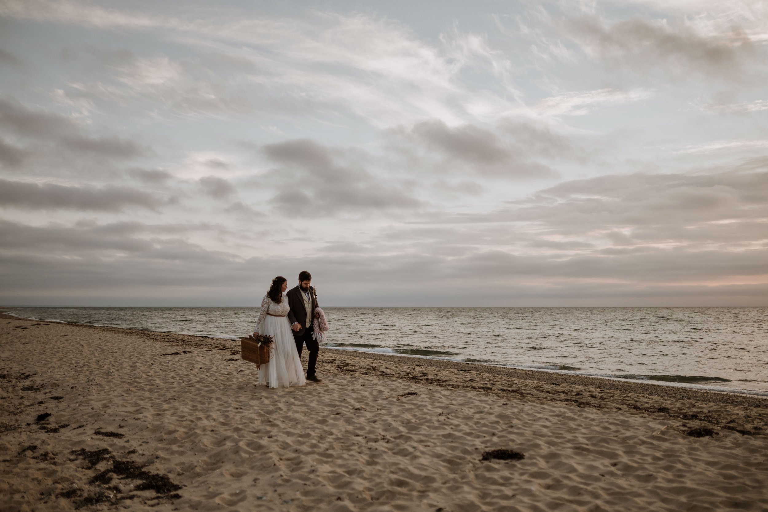 Newlywed couple exploring the beach for their elopement.