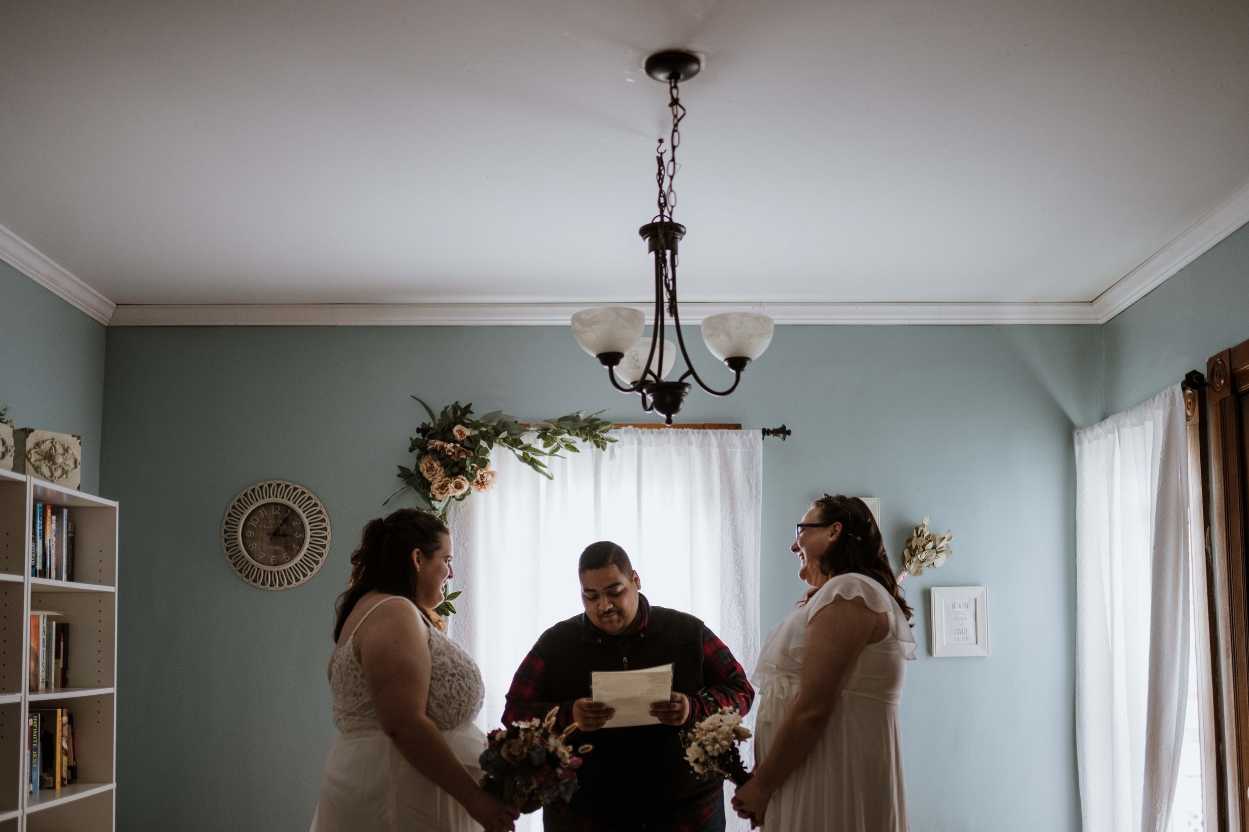 An eloping couple exchanging vows in their new home.