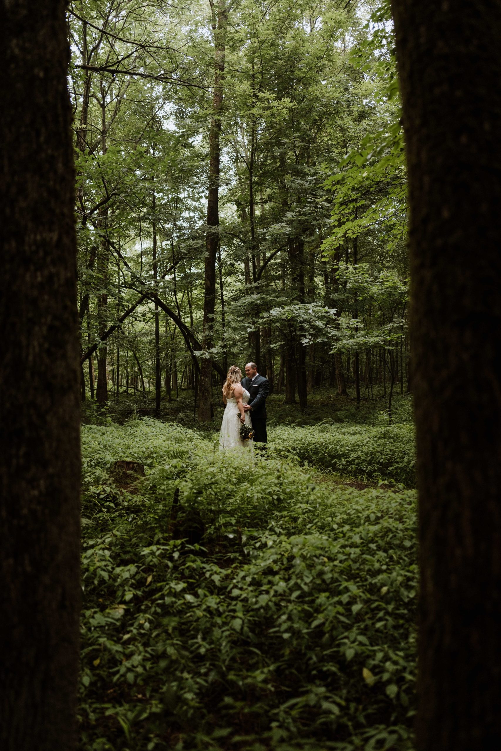 An eloping couple enjoying a few moments of privacy out on a forest trail.