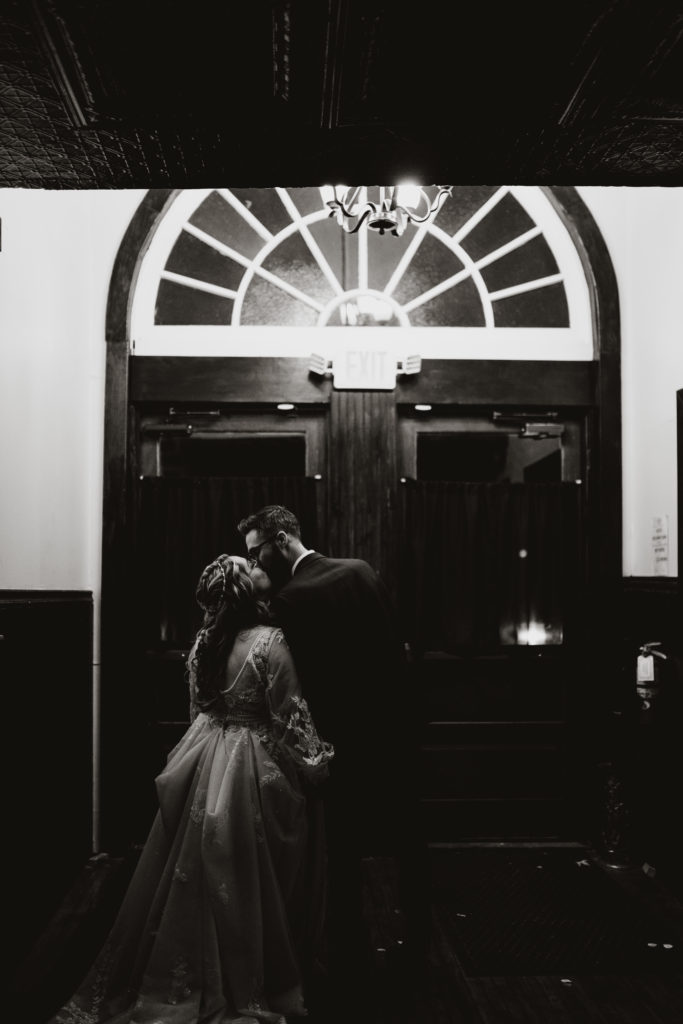 Black and white portrait at Sackets Harbor Ballroom of newlywed couple.